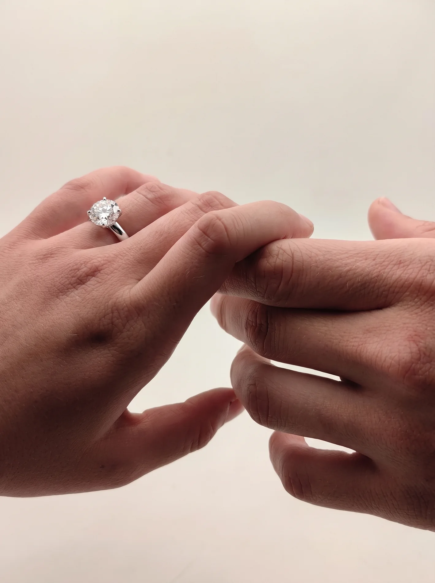 The legacy solitaire held between hands.